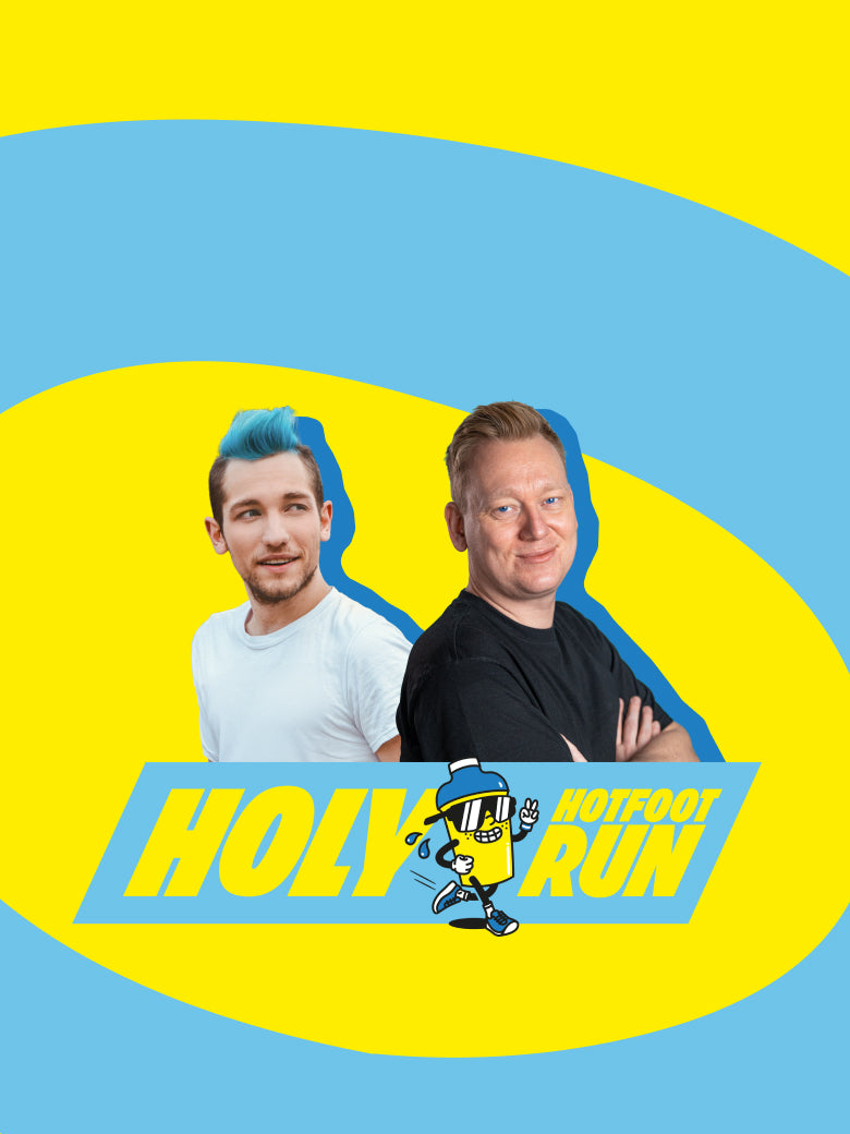Zwei Personen lächeln vor einem farbenfrohen Hintergrund mit dem Text "Holy Hotfoot Run" und einer laufenden Cartoon-Figur.